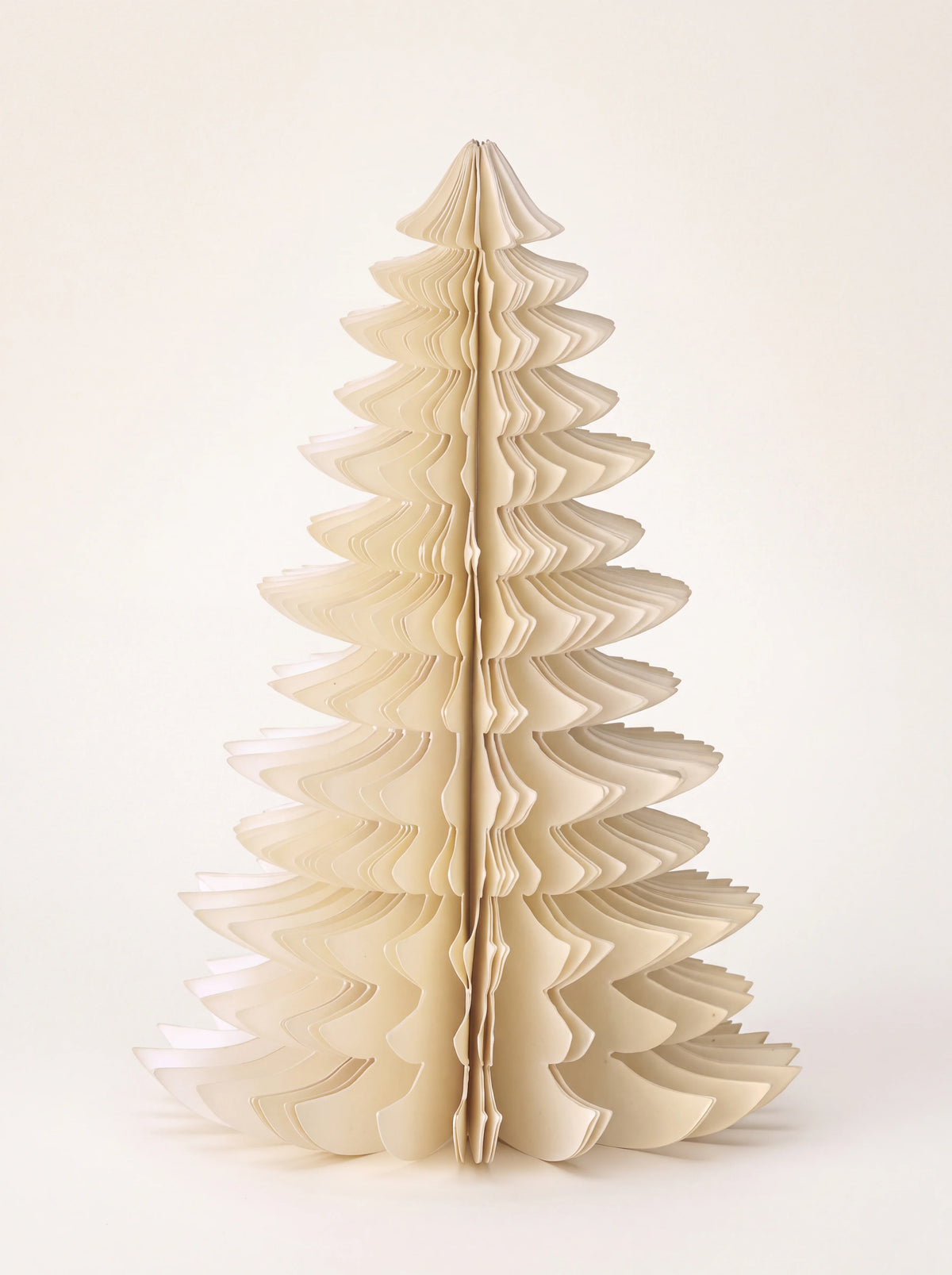 Freestanding paper honeycomb tree with tiered branches in off-white