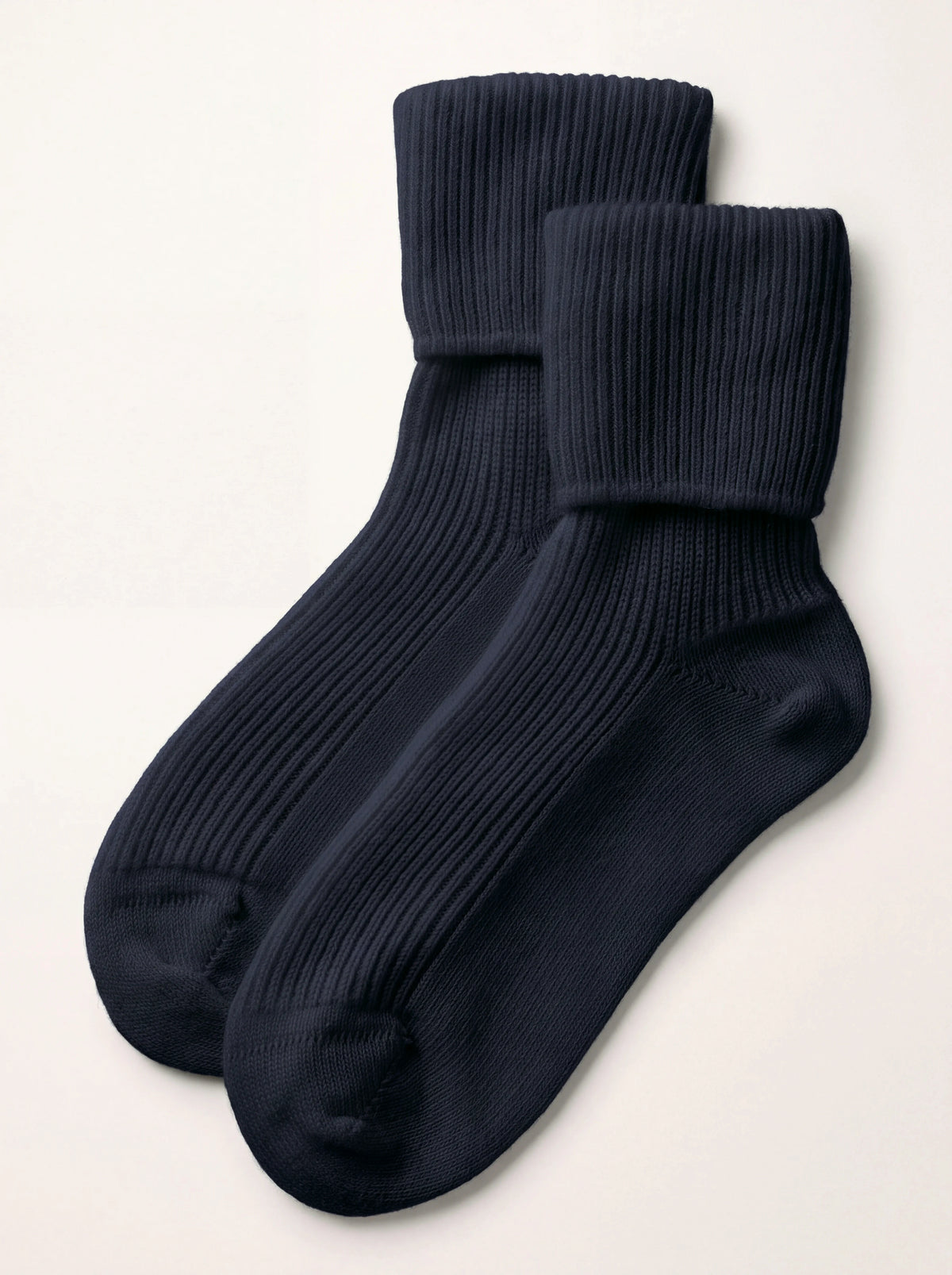 Dark navy cashmere travel socks with a ribbed body and fold-over cuffs