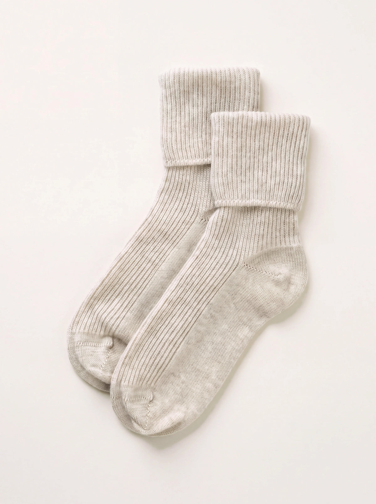 Pair of sand cashmere lounge socks with ribbed bodies and fold-over cuffs