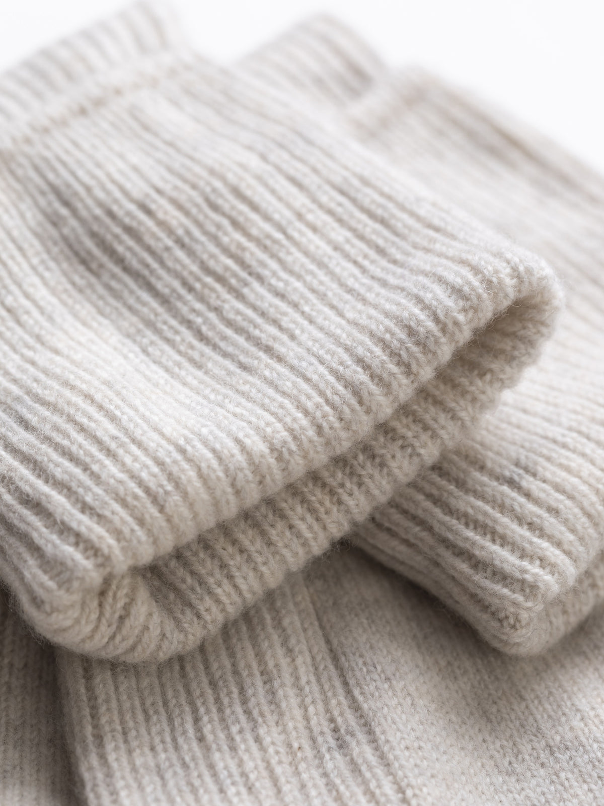 Close-up of the ribbed fold-over cuff showing the soft cashmere knit texture
