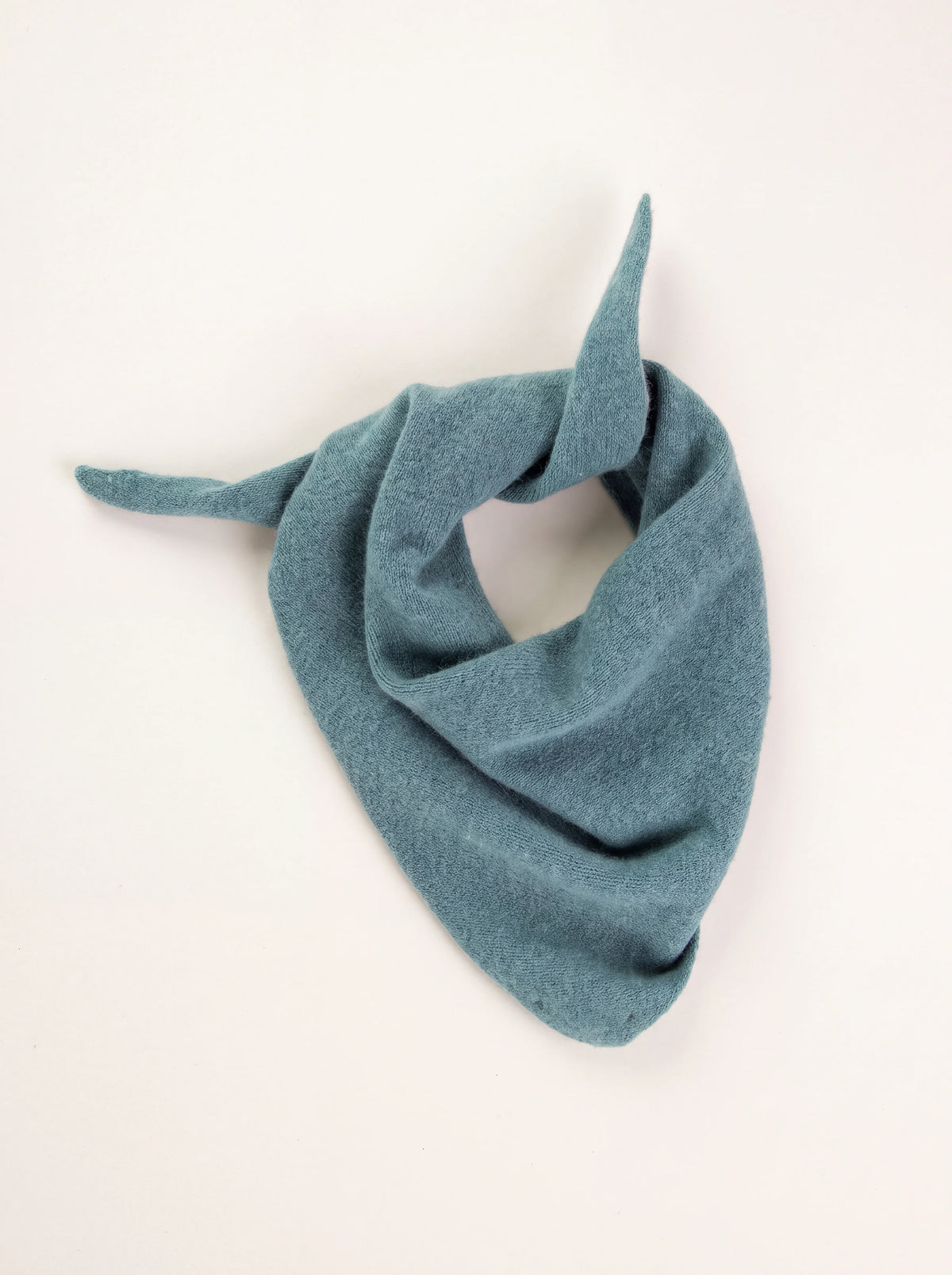 Fine-knit lambswool bandana in muted teal blue, draped with tapered ends