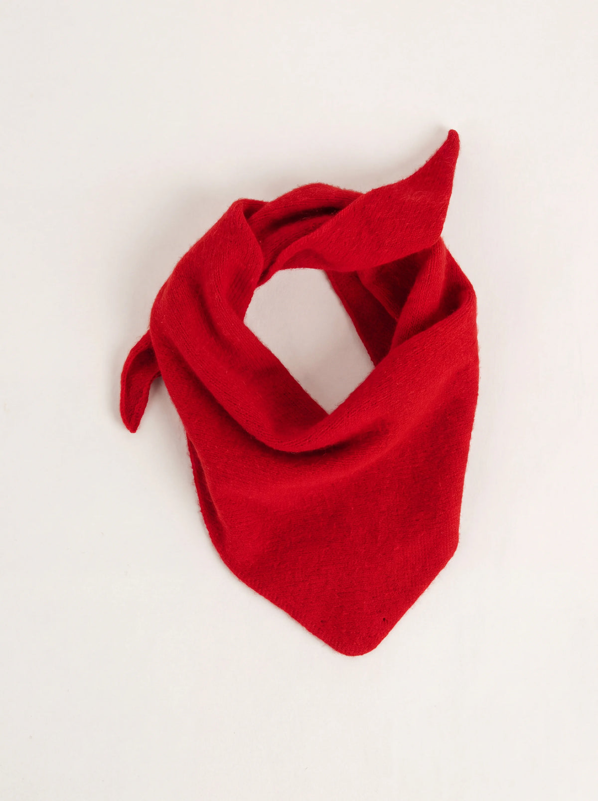 Crimson knitted wool bandana loosely folded with a triangular front and tapered ends