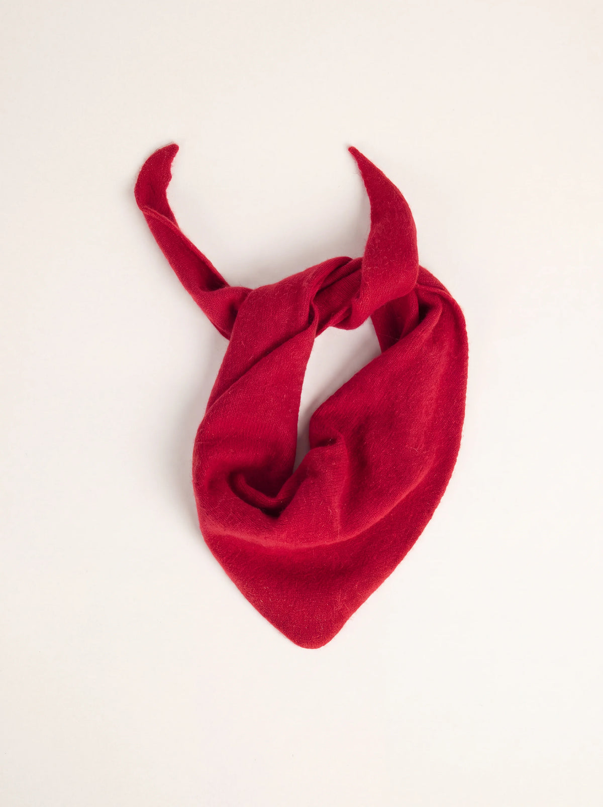 Knitted framboise red lambswool bandana loosely tied in a neck loop with tapered ends