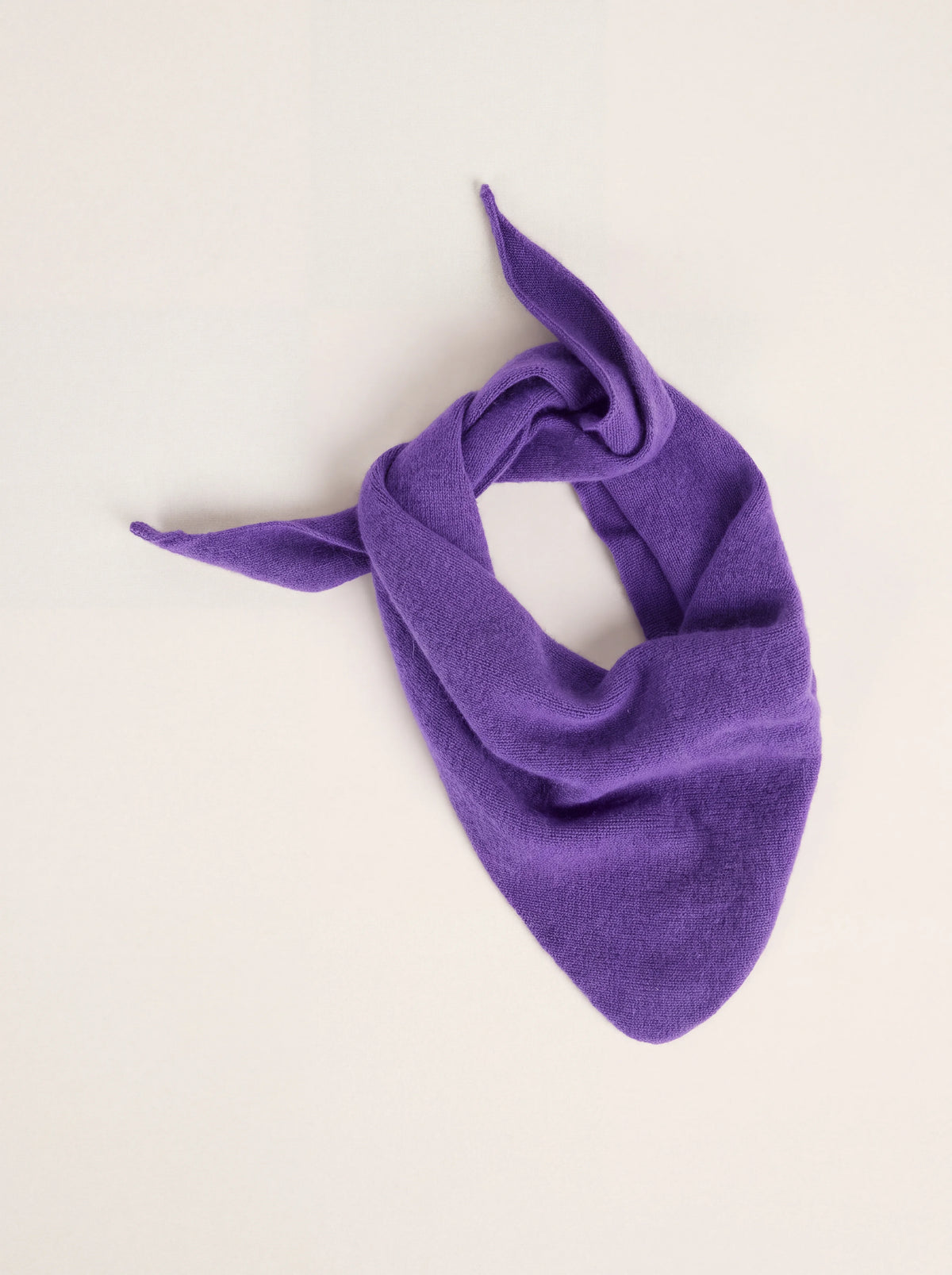 Grape purple knitted wool bandana tied loosely with tapered ends