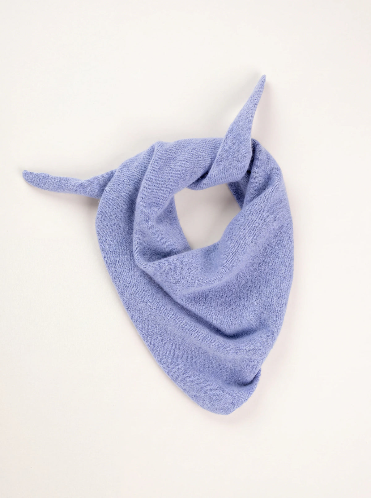 Light blue knitted wool bandana draped in a triangle with loosely tied tapered ends