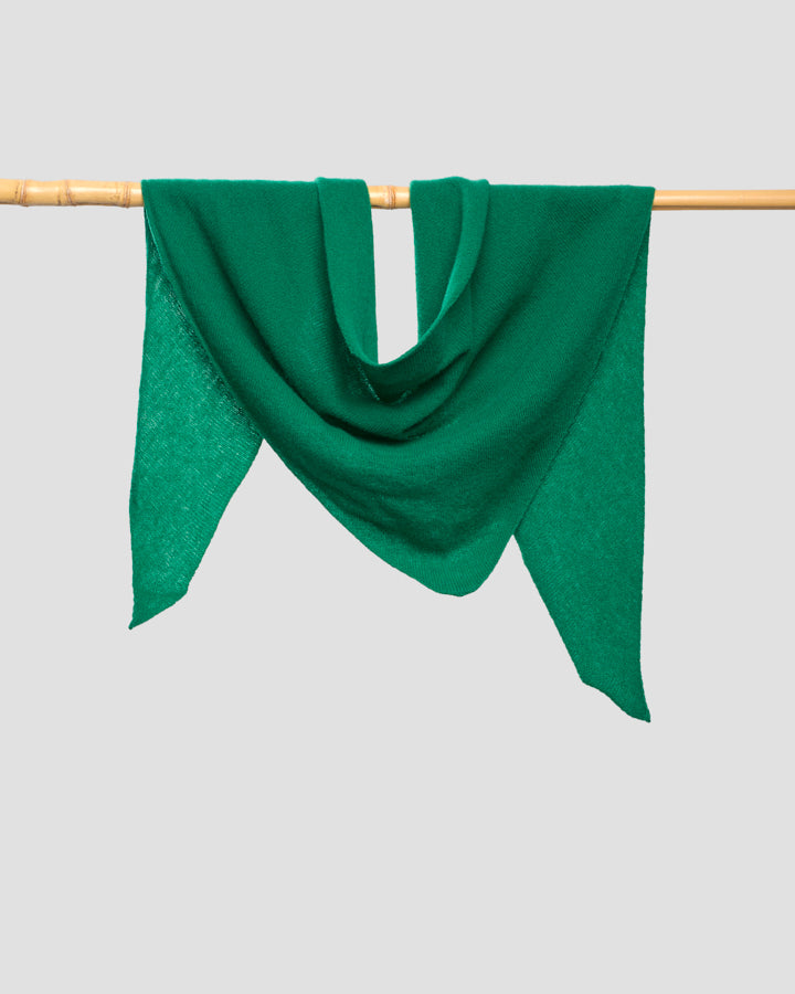 Mint green merino wool bandana draped over a wooden rail showing its triangular shape and fine weave