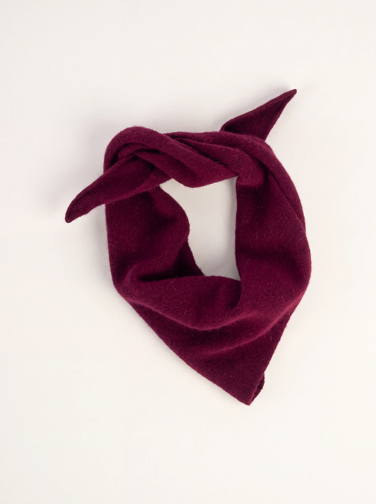 Wine red knitted lambswool bandana, loosely tied into a triangular neckerchief