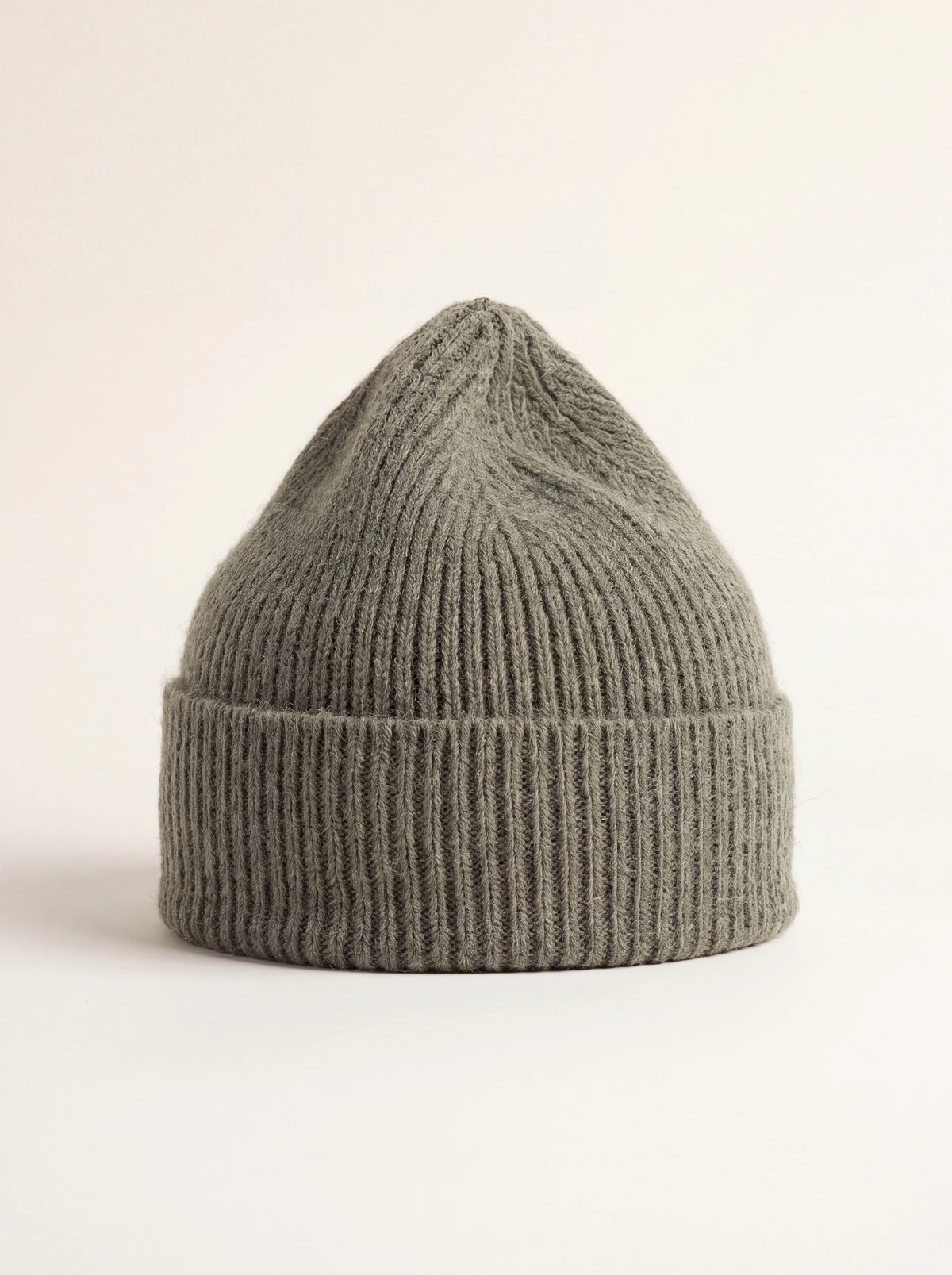 Ribbed lambswool beanie in muted clay green with a wide turn-up cuff
