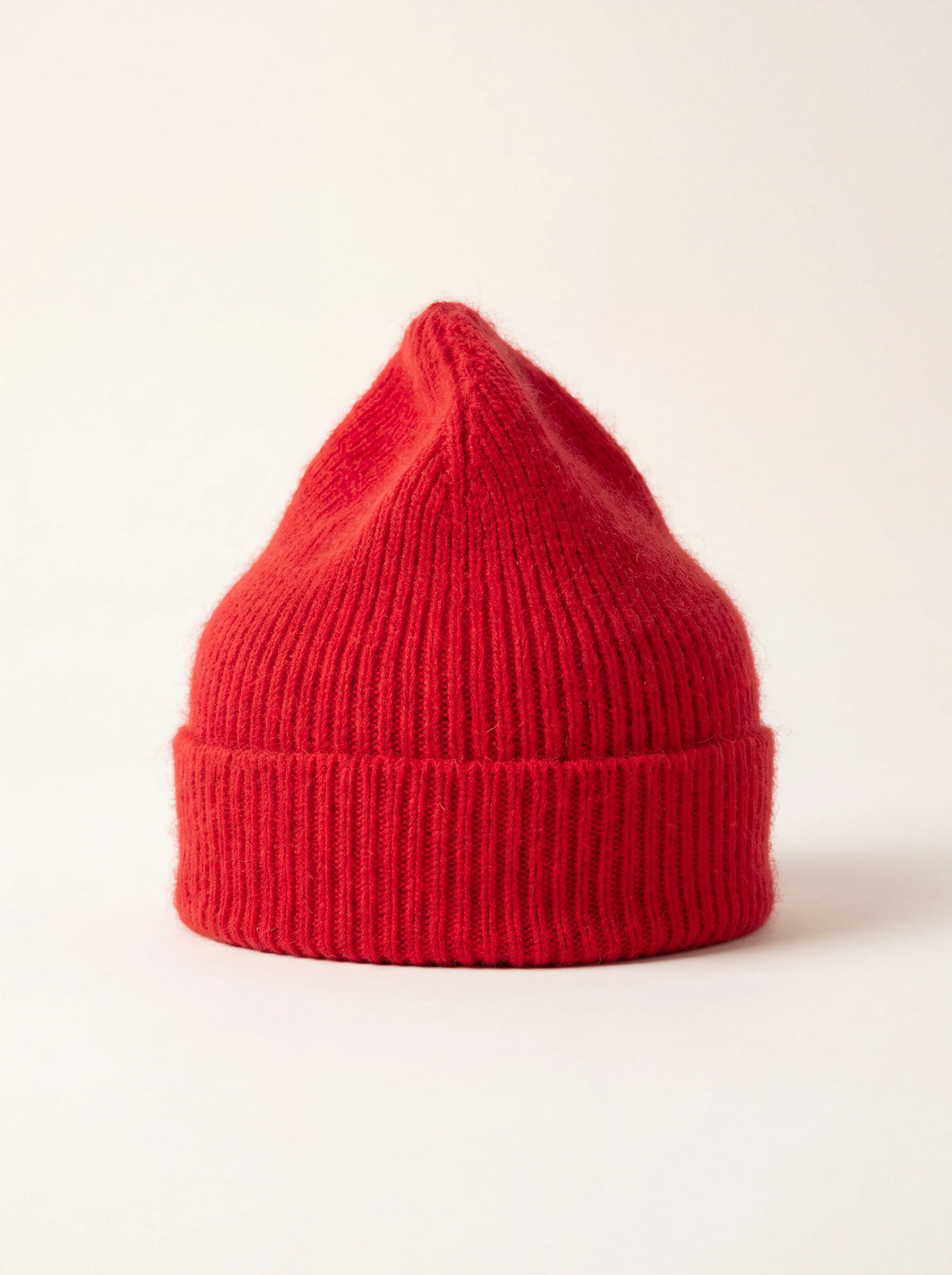 Crimson red ribbed wool-blend beanie with a wide turn-up cuff and tapered crown
