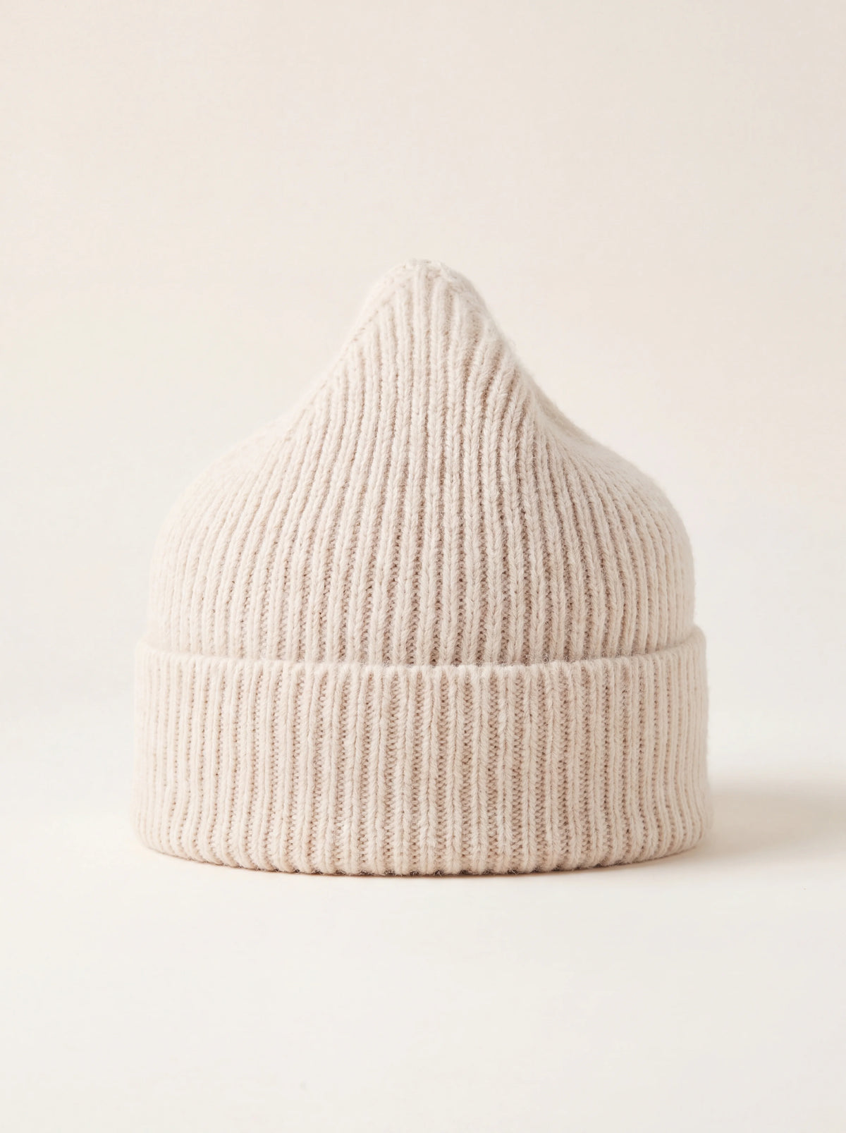 Ivory ribbed wool beanie with a wide turned-up cuff and pointed crown