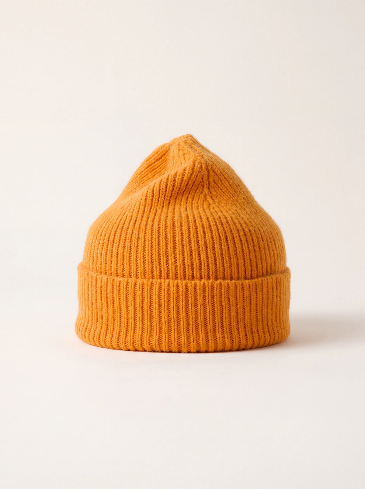 Ribbed knit wool beanie in bright orange with a wide folded cuff