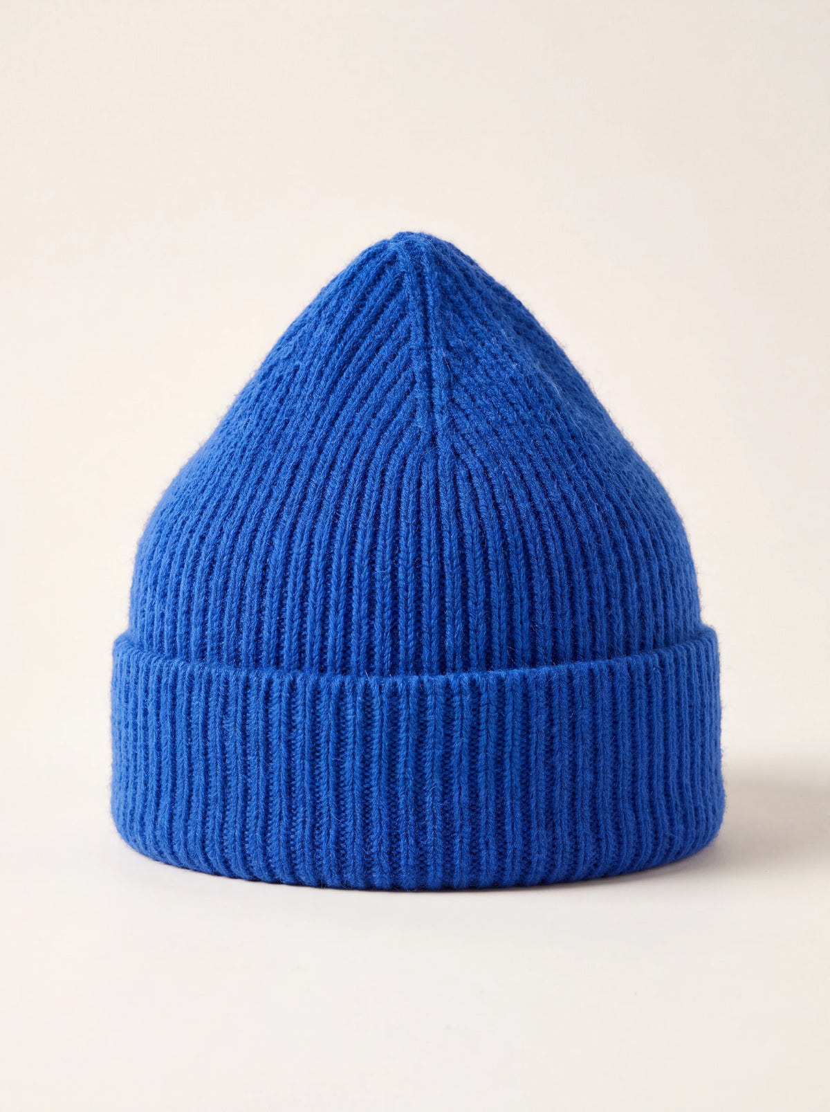Bright blue ribbed wool beanie with a wide folded cuff and peaked crown