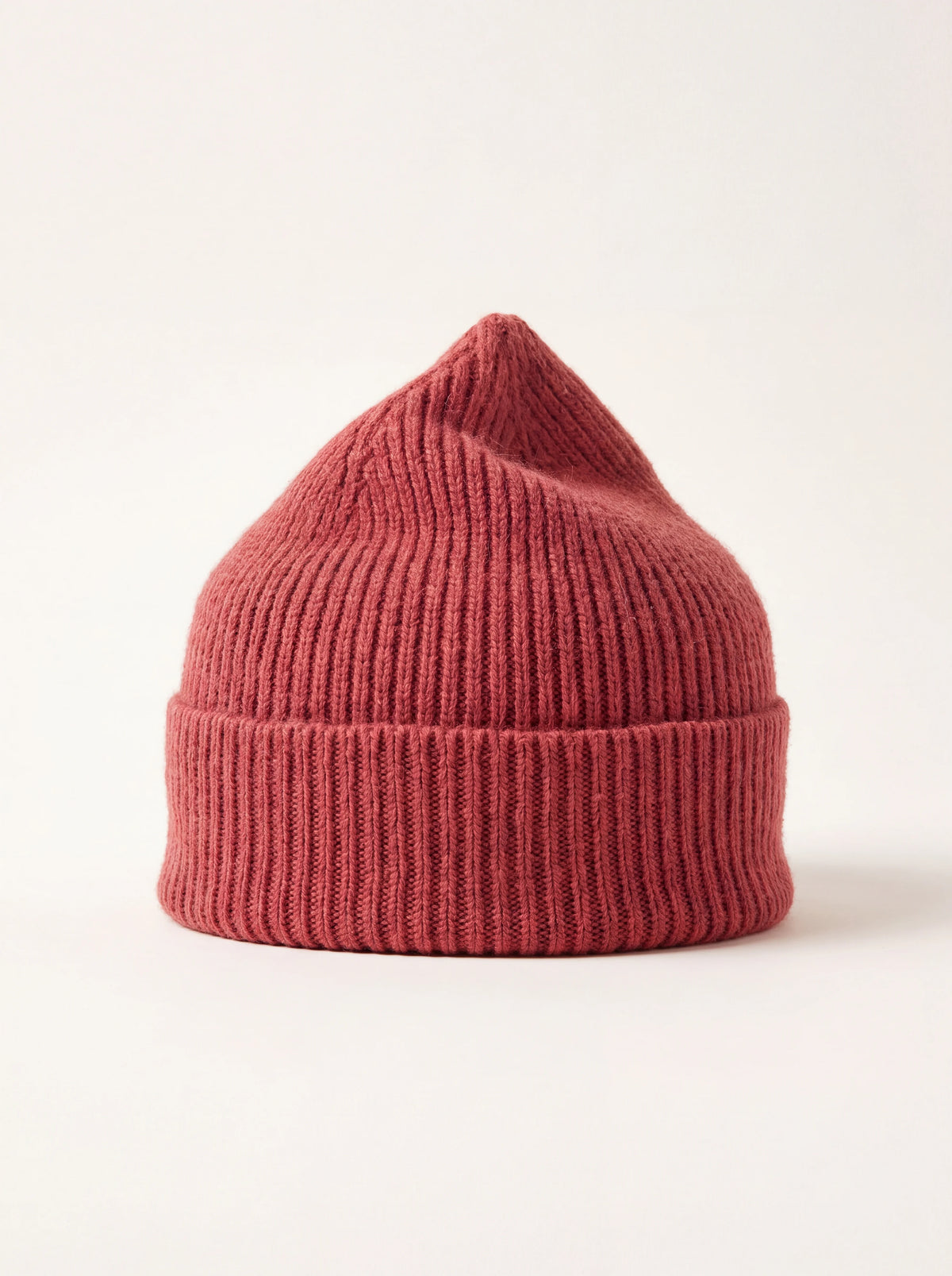 Terracotta red ribbed knit lambswool beanie with a wide turn-up cuff