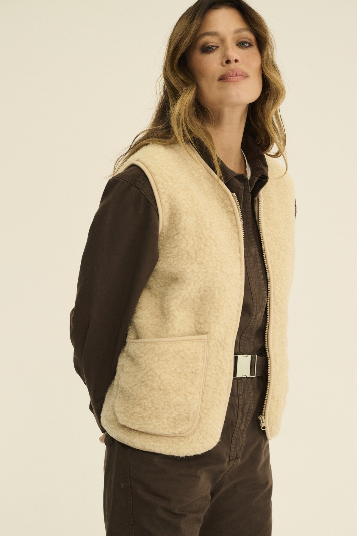 Beige Merino wool fleece vest with a front zip, stand collar and bound edges