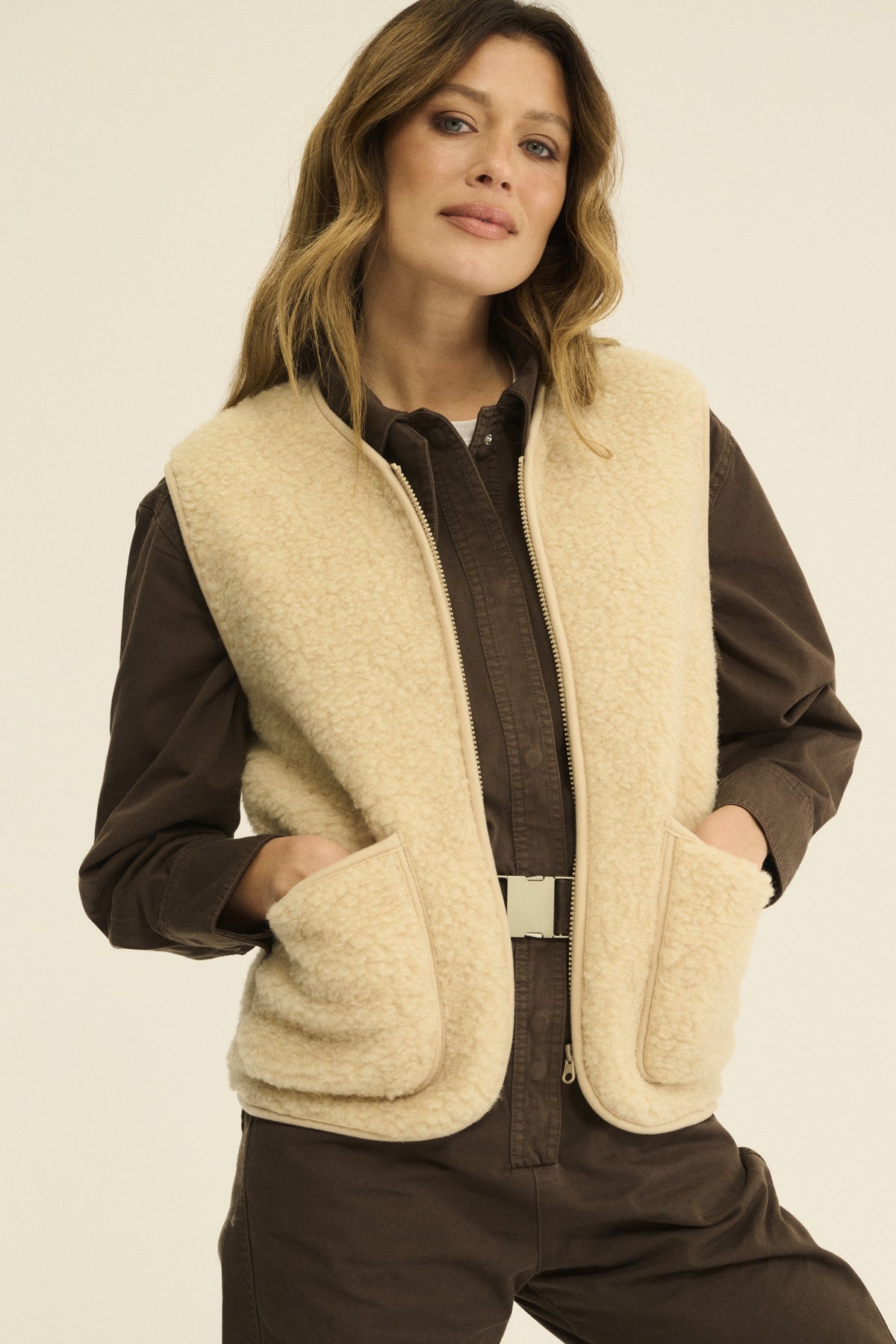 Front view of the beige Merino wool fleece vest showing both patch pockets