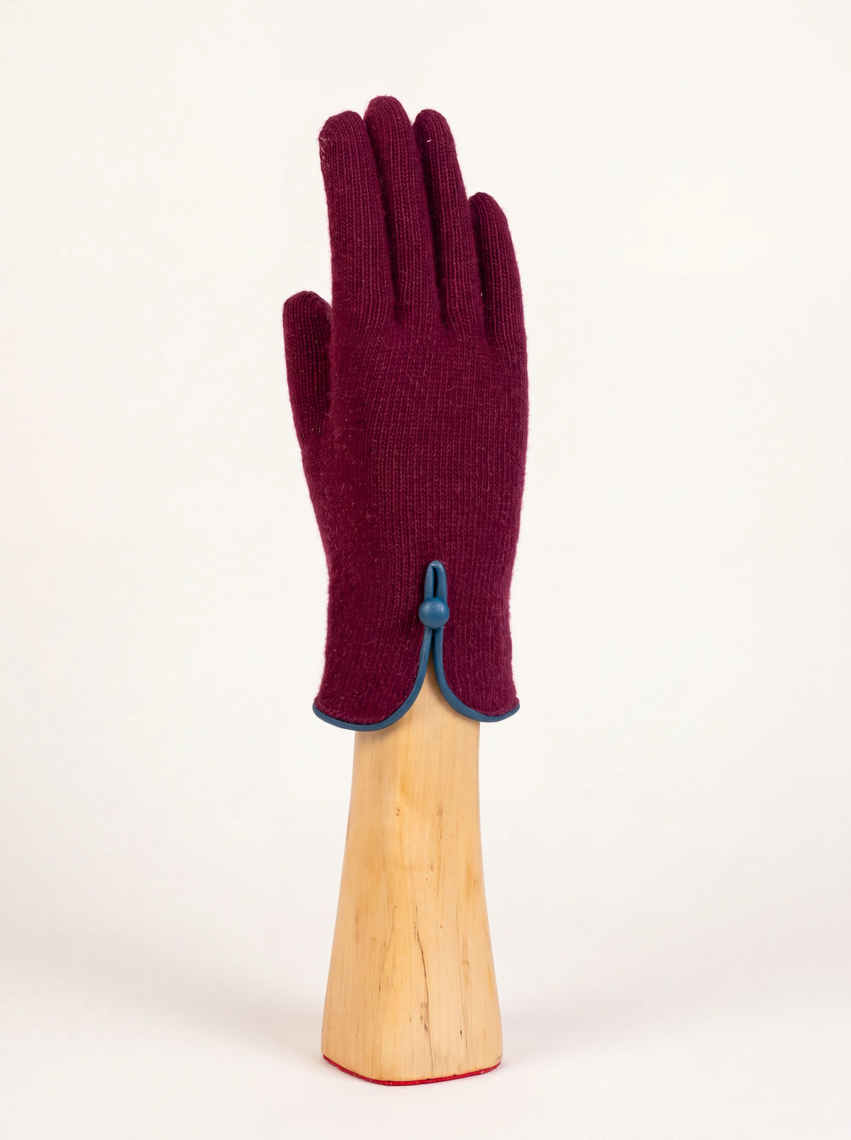 Burgundy knitted wool and cashmere glove showing slit cuff with blue piping and button detail