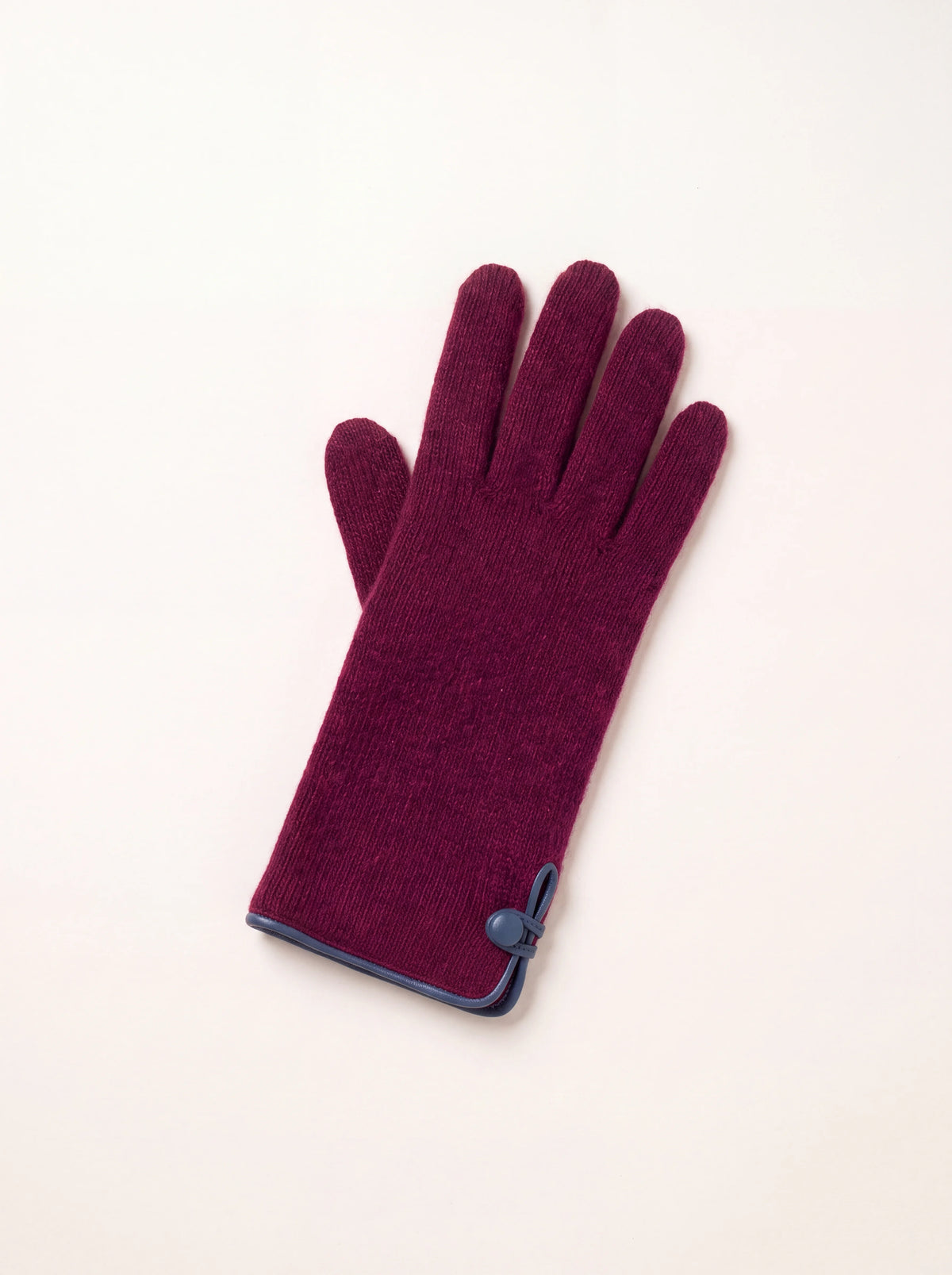 Knitted burgundy wool and cashmere glove with cuff slit, contrasting leather piping, and matching button