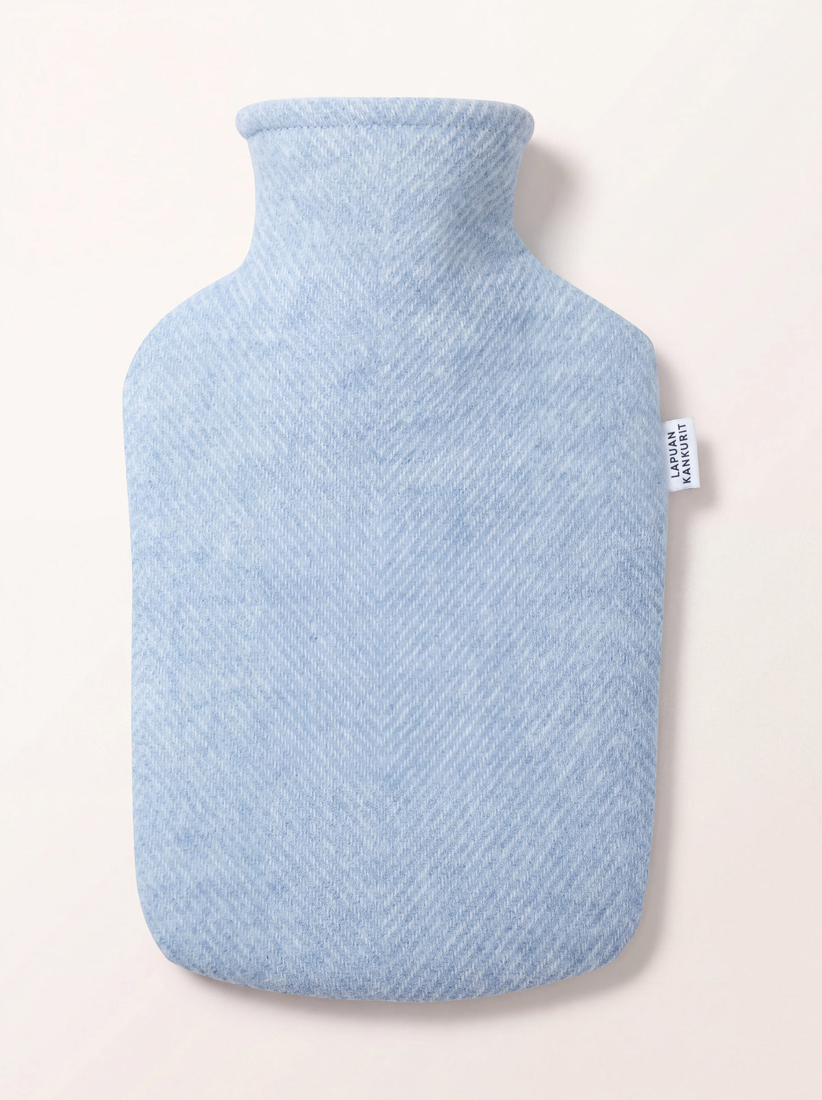 Hot water bottle in a light blue herringbone wool cover with a LAPUAN KANKURIT side label
