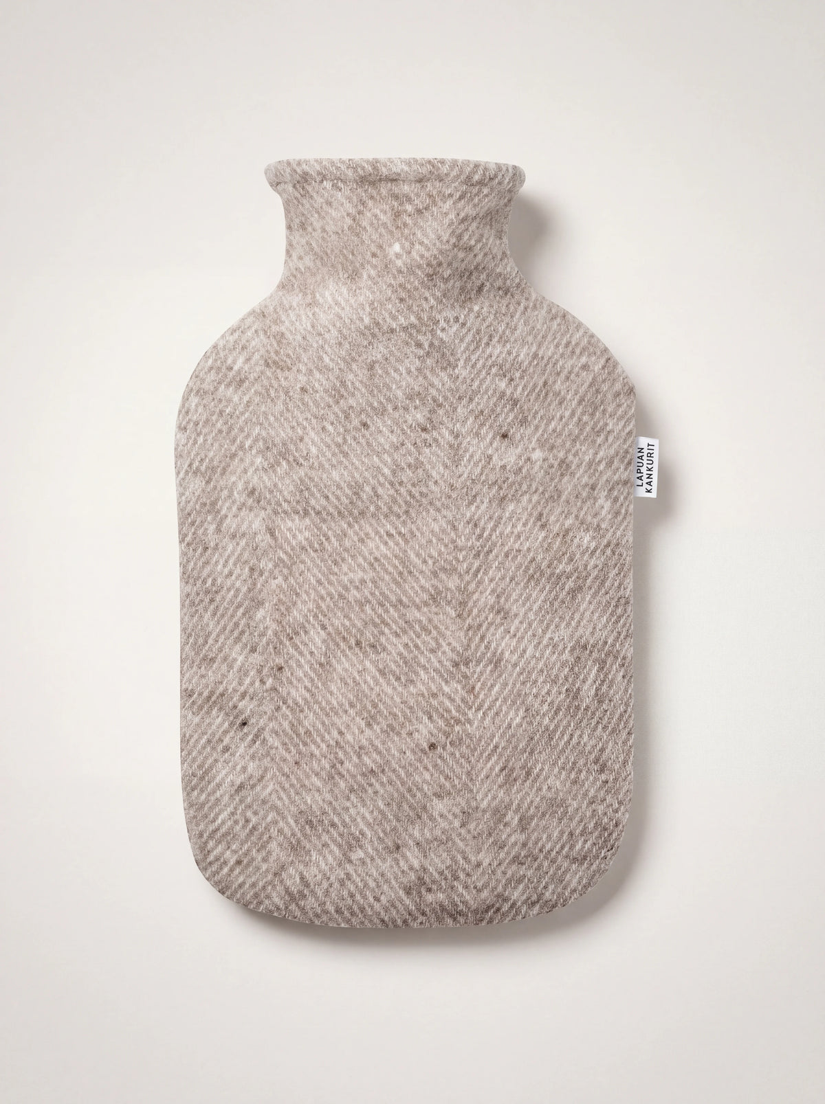 Beige wool hot water bottle in a herringbone weave with a Lapuan Kankurit label tag