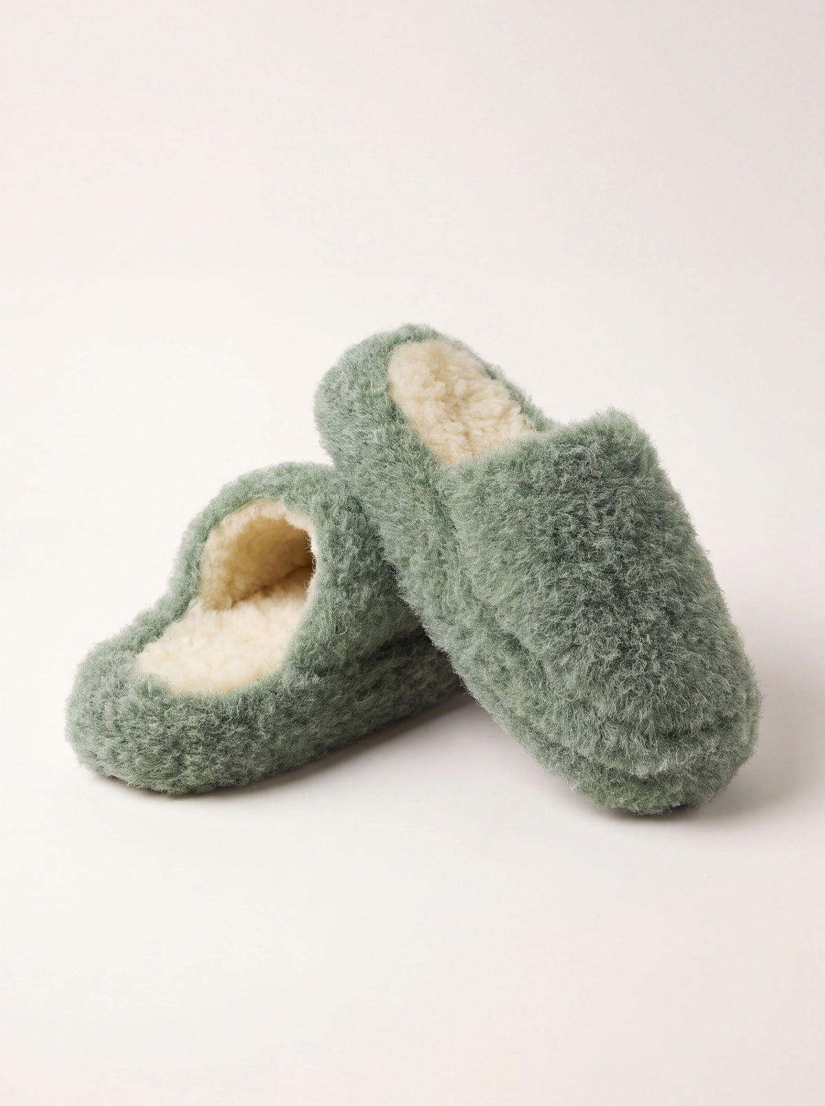 Green sheep wool fleece mule slippers with open backs and contrasting cream lining