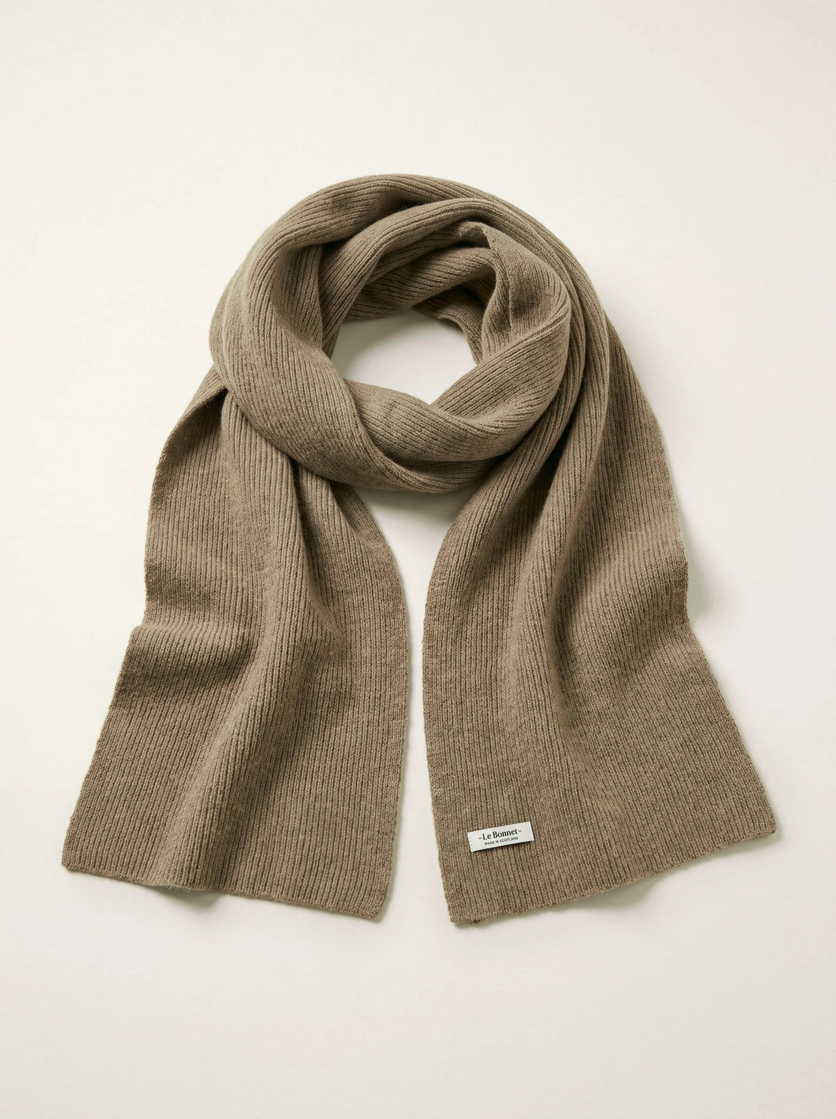 Clay ribbed lambswool scarf draped in a loop with a -Le Bonnet- label stitched near the hem