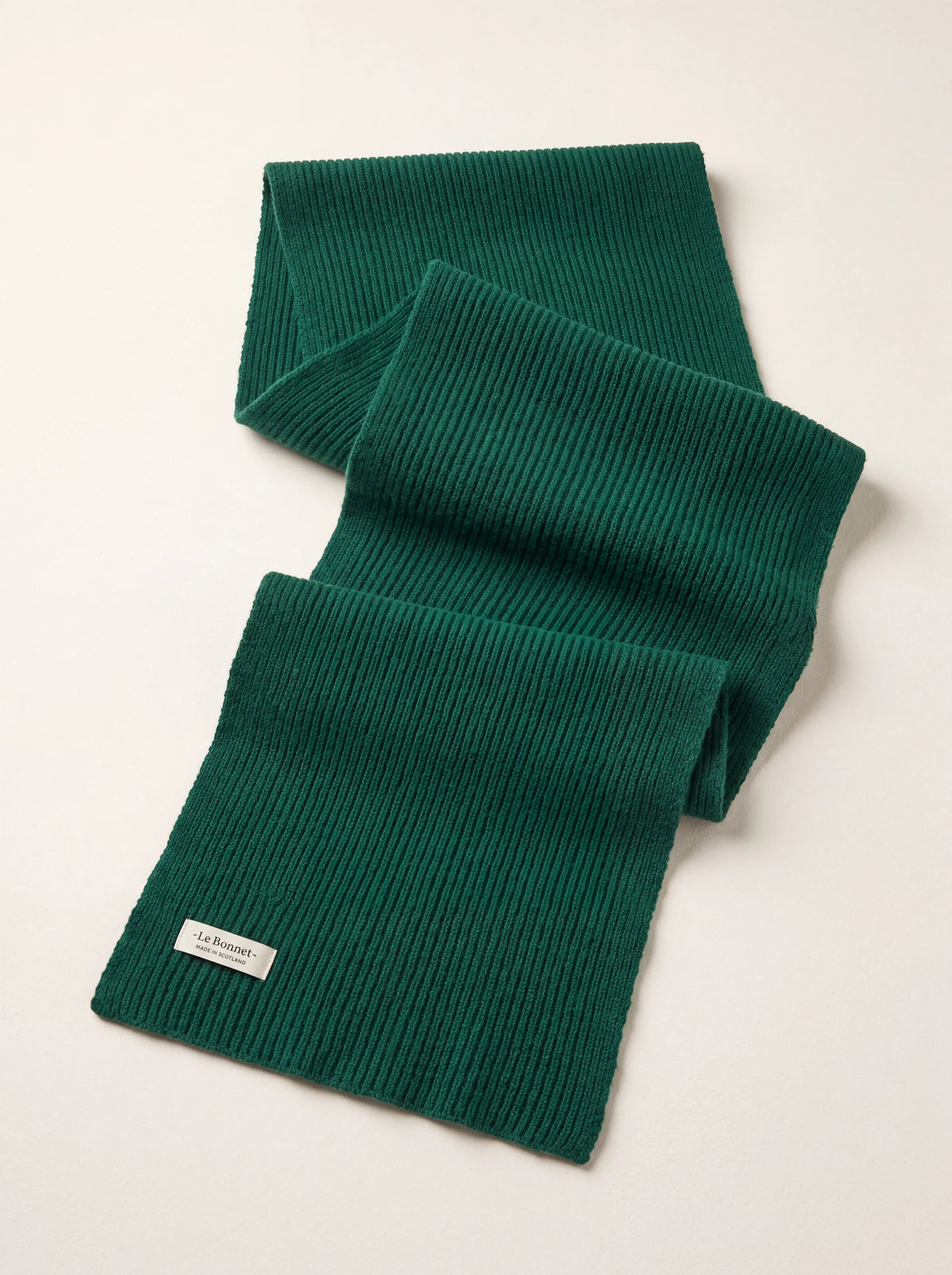 Ribbed pine green lambswool scarf, folded, with a stitched Le Bonnet Made in Scotland label
