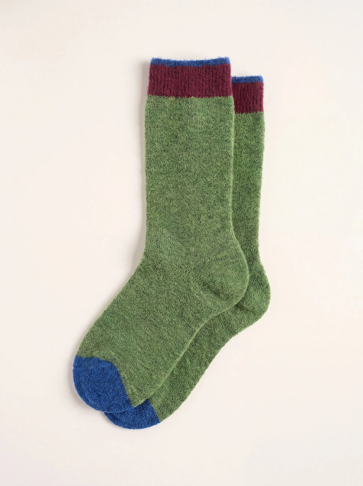 Green wool-blend socks with a burgundy and blue ribbed cuff and blue toes