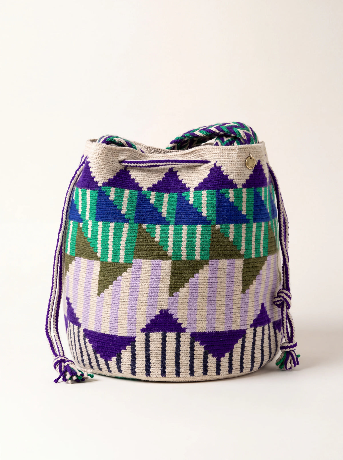 Woven acrylic shoulder bag with geometric patterns in purple, royal blue and lilac, with a drawstring closure