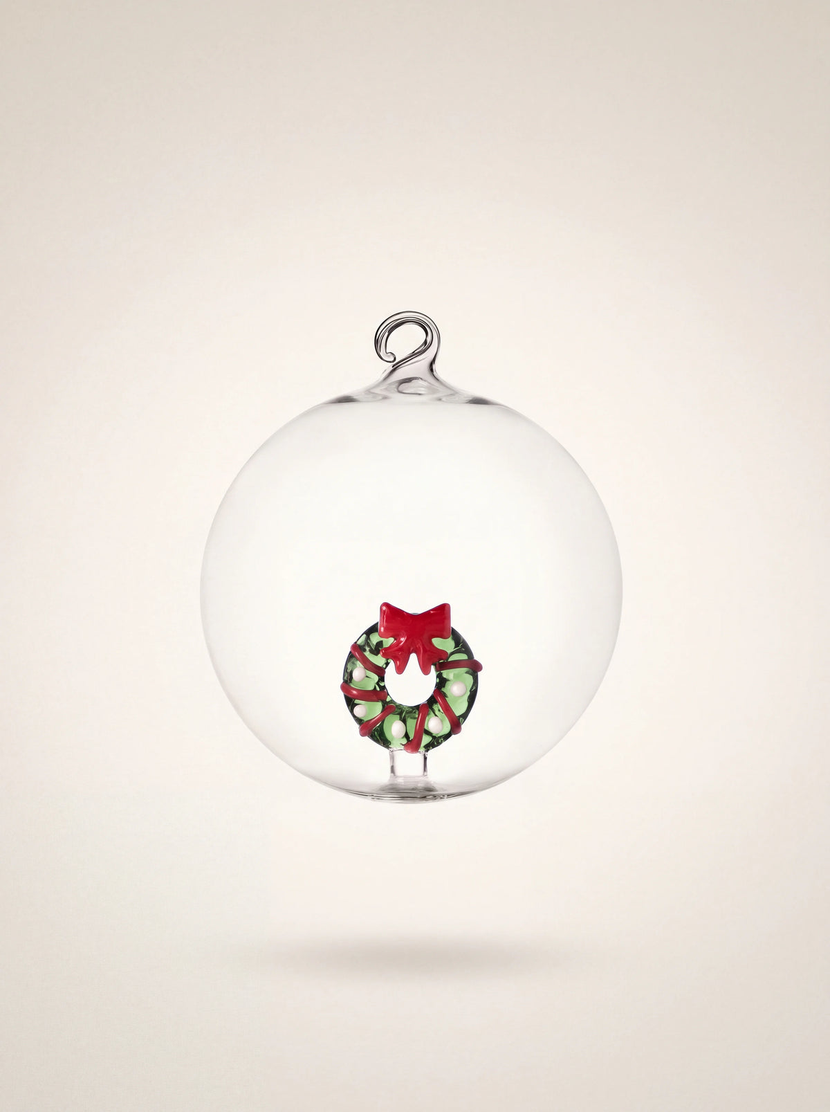Clear glass bauble with a hanging loop and an internal green Christmas wreath with a red bow