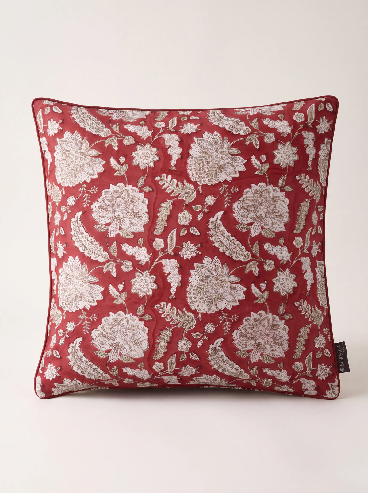 Square raspberry cotton cushion with beige floral block print and piped edges